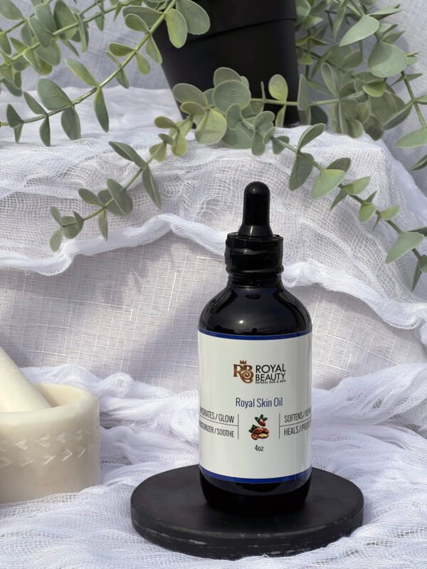Royal Skin Oil on black disc with plant in background