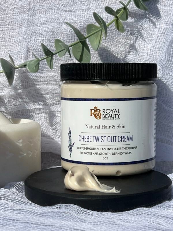 Product on black disc with smear of product and ivy green in background